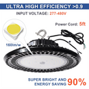 Close-up of TANLITE LED high bay light showing voltage range (277V-480V), 200W power, and 5-year warranty label